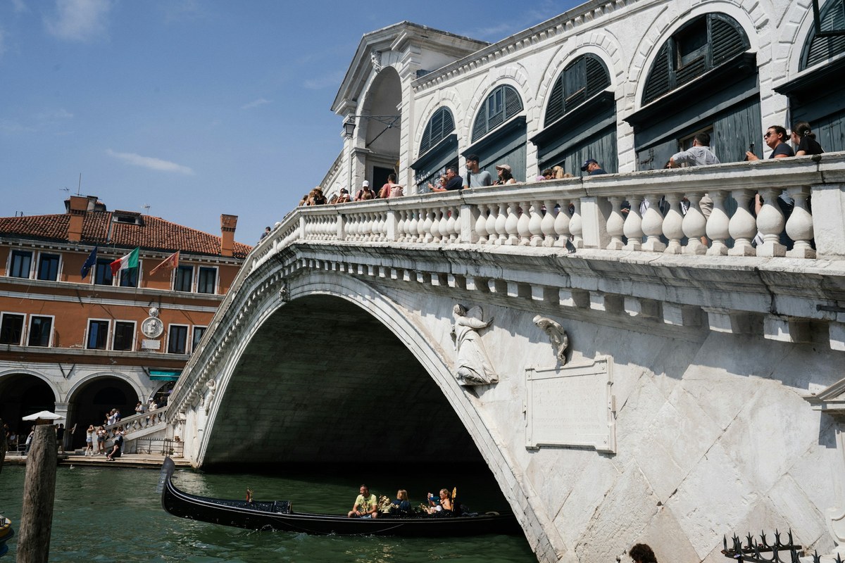 Rialto Bridge and gondola on the Grand Canal in Venice, Italy