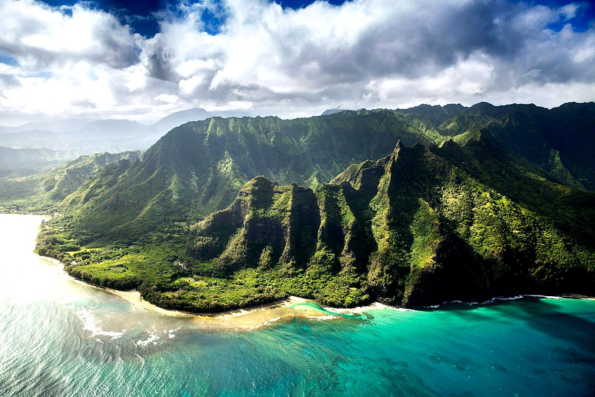 Green Hawaiian coastline meeting blue Pacific water