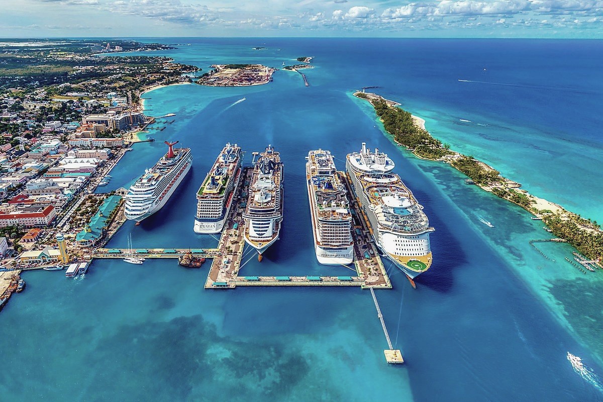 Aerial view of cruise ships docked in a tropical harbor
